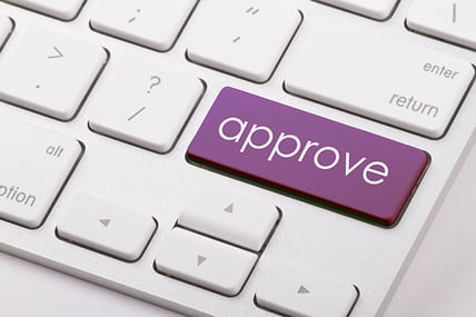 financing approved on computer keyboard