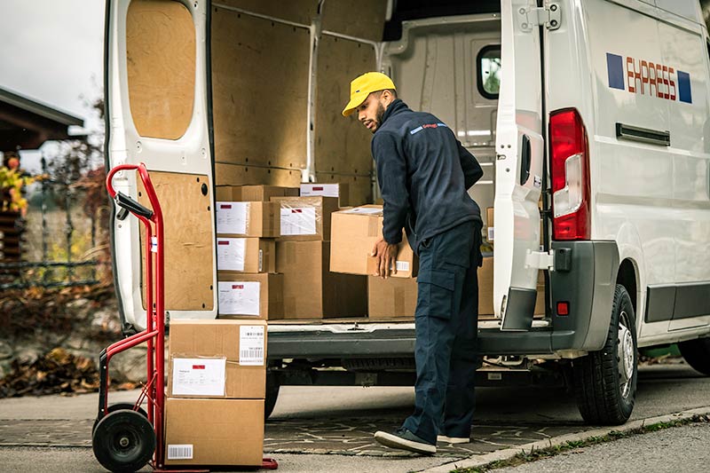 worker unloading packages from a box truck