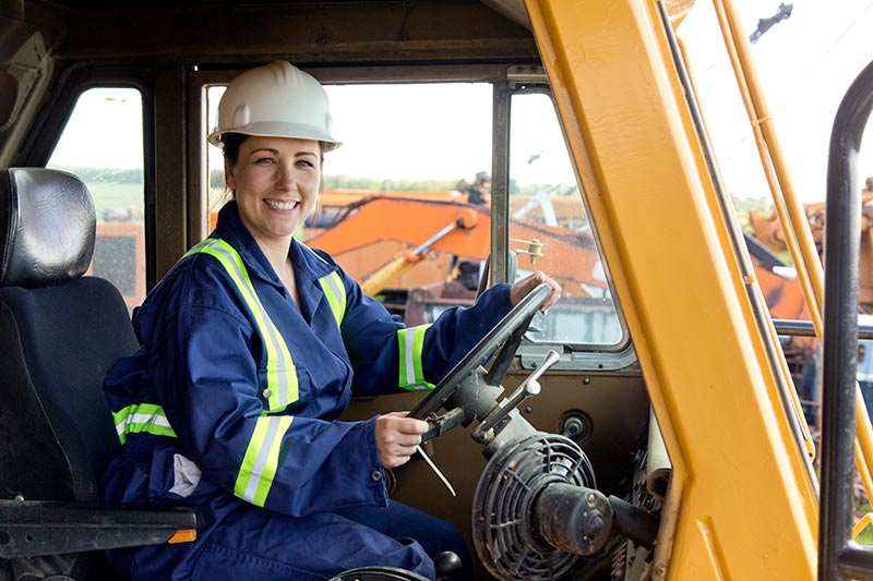 smiling female dump truck operator