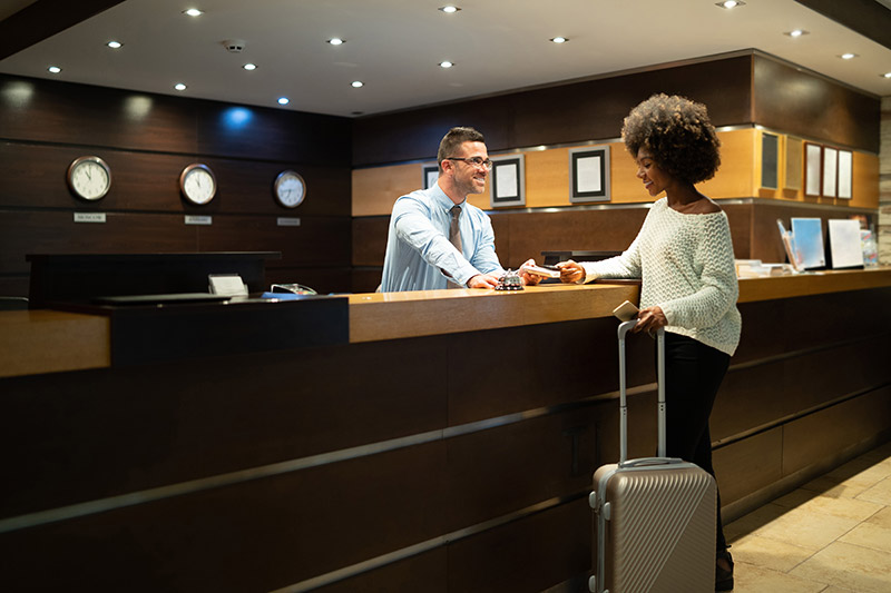 smiling woman checking into a hotel