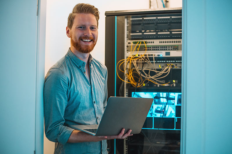 information technology specialist checking computer servers