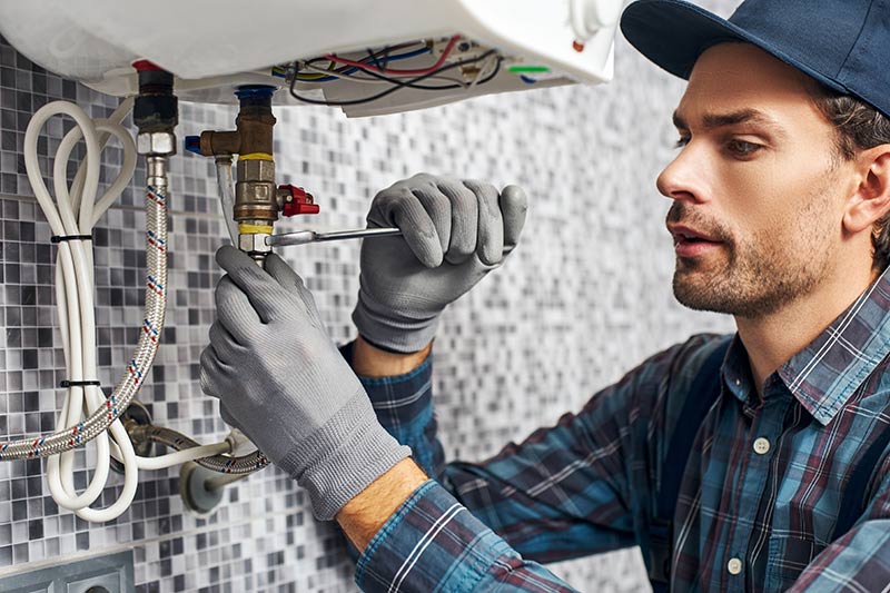 professional plumber working on sink