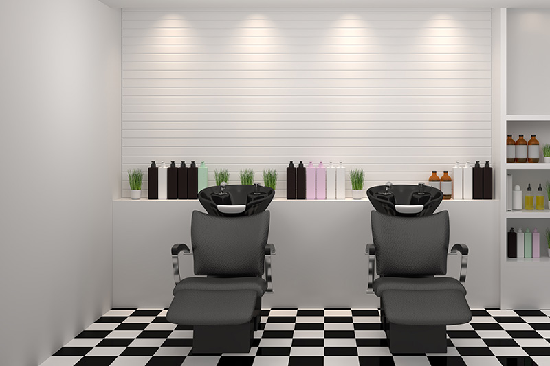 two shampoo chairs and bowls in a modern beauty salon