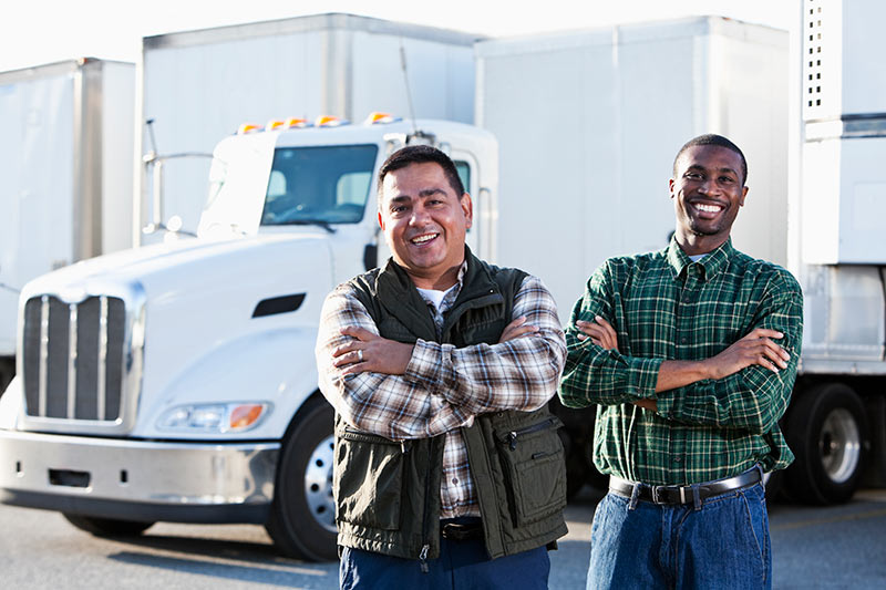 two smiling truck drivers ready for work
