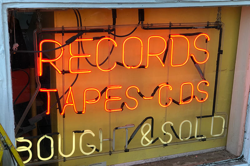 neon record store sign in a shop window