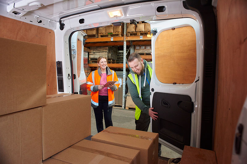 delivery workers emptying a cargo van