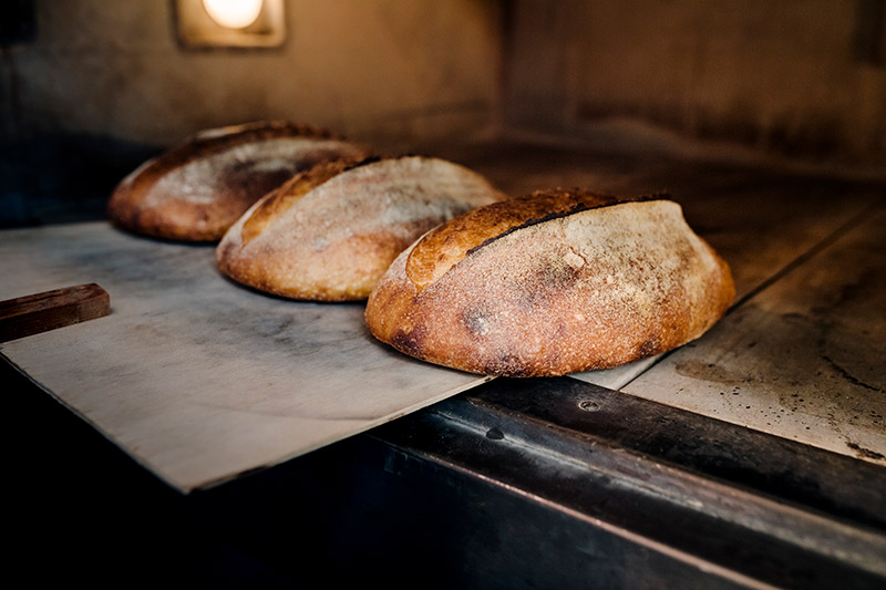 loaves of sourdough bread in a commercial oven