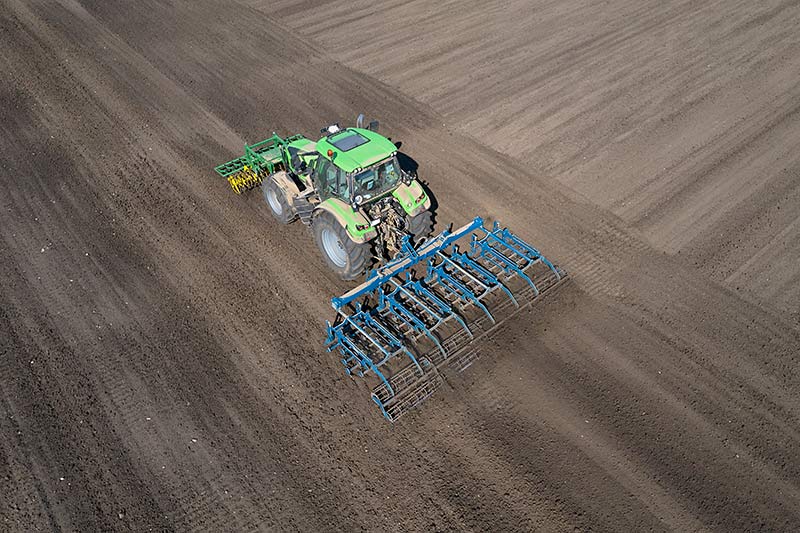 overhead view of farm cultivator working soil