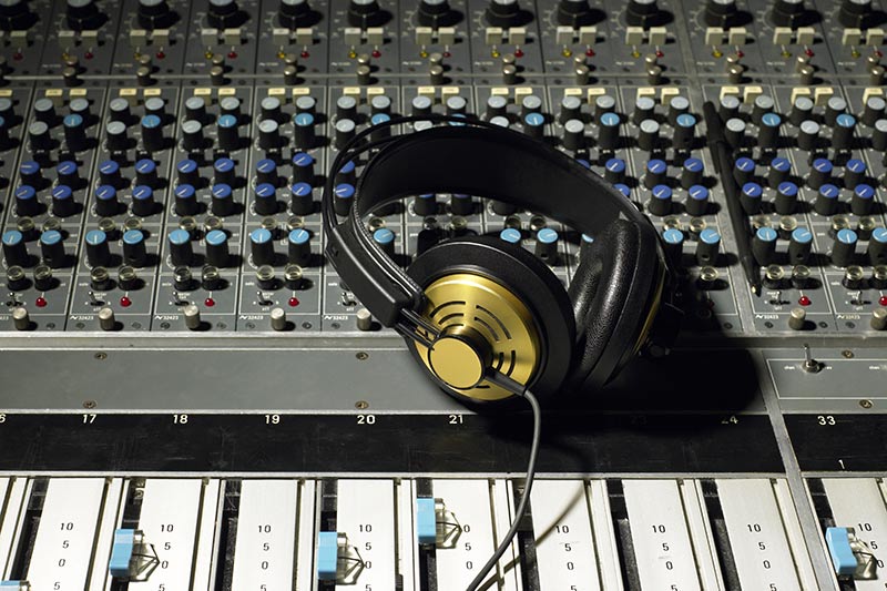 headphones on a large studio mixing board