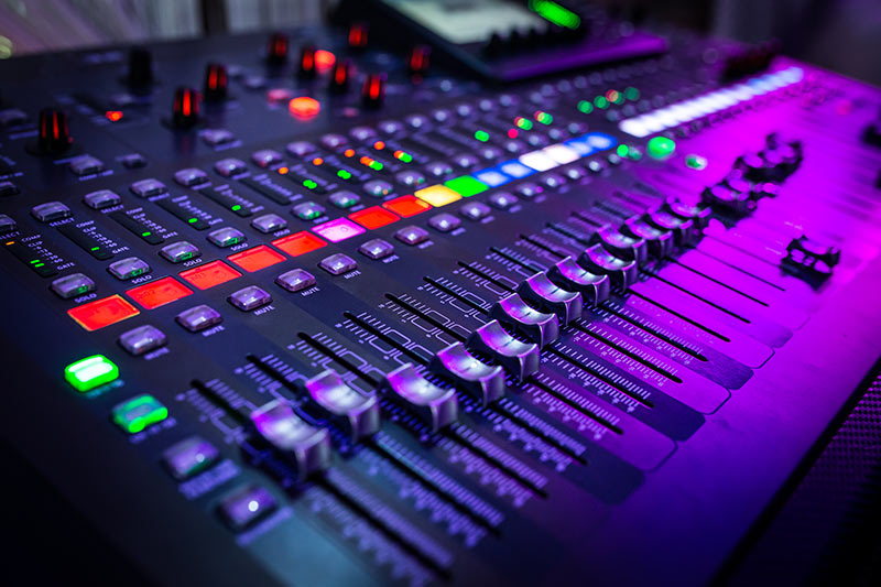 soundboard financing, colorful mixing board with lots of lights and buttons