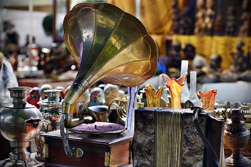 vintage phonograph player and other antiques on display