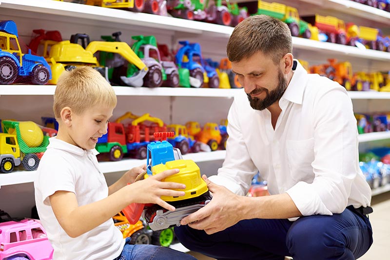 father and son shopping for toys, toy store business loans