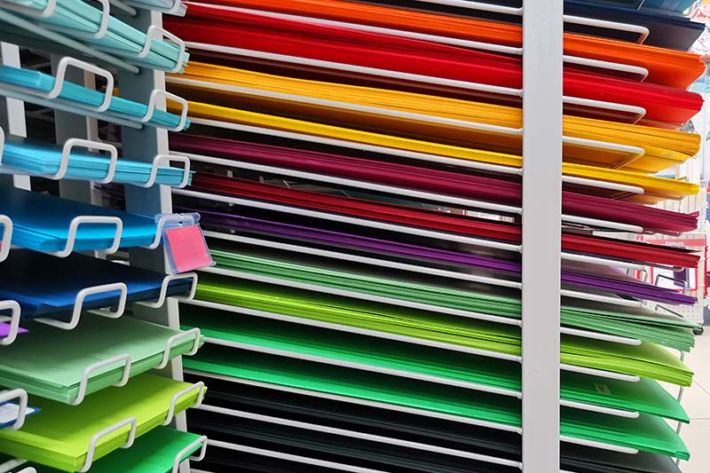 rows of colorful paper at art shop, art supply store business loans
