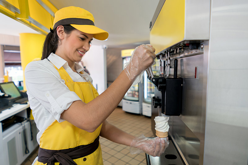 female ice cream shop worker making a cone, ice cream machine financing