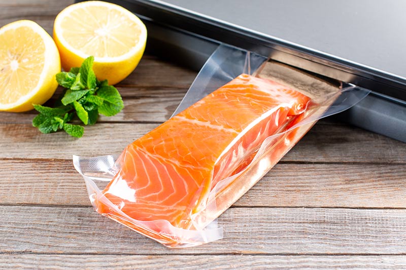 piece of fresh salmon being shrink wrapped, shrink wrap machine financing