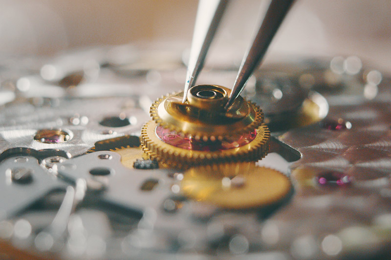 close up of watch dial being replaced on a wristwatch