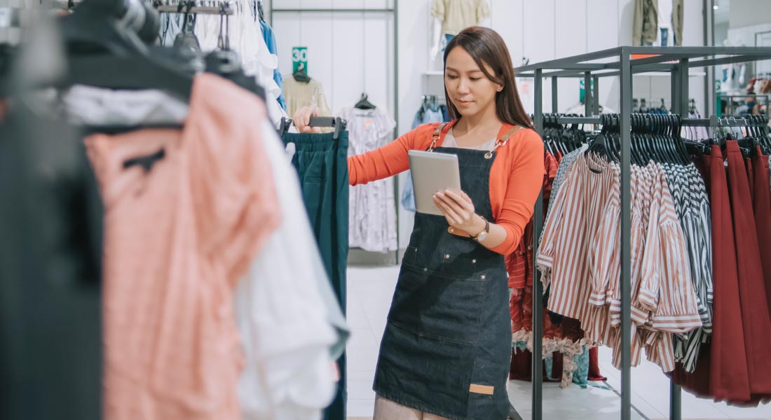 female clothing store owner checking inventory, how to manage business inventory
