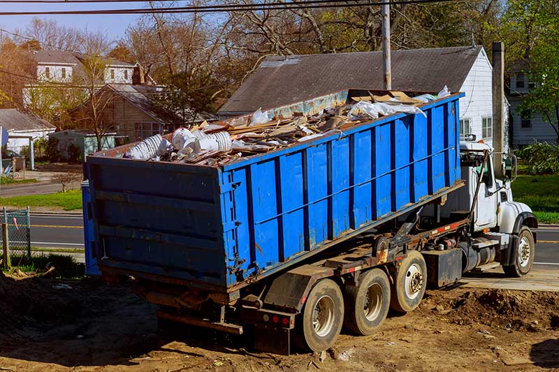 large blue roll-off truck hauling debris, roll-off truck financing