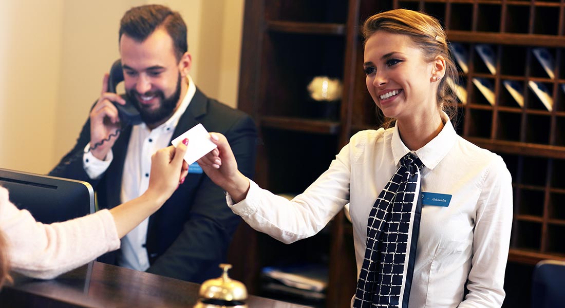 how to increase your hotel occupancy rate, hotel manager on phone at check in desk