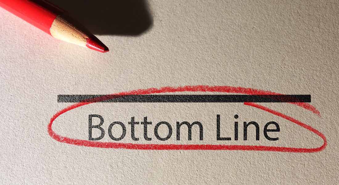understanding the bottom line in business, red pencil next to bottom line text