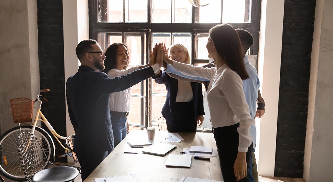 team of workers celebrating success, how to motivate your employees