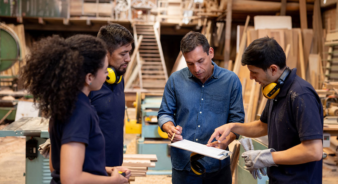 carpentry workers discussing tasks in the workshop, signs you need to upgrade your equipment