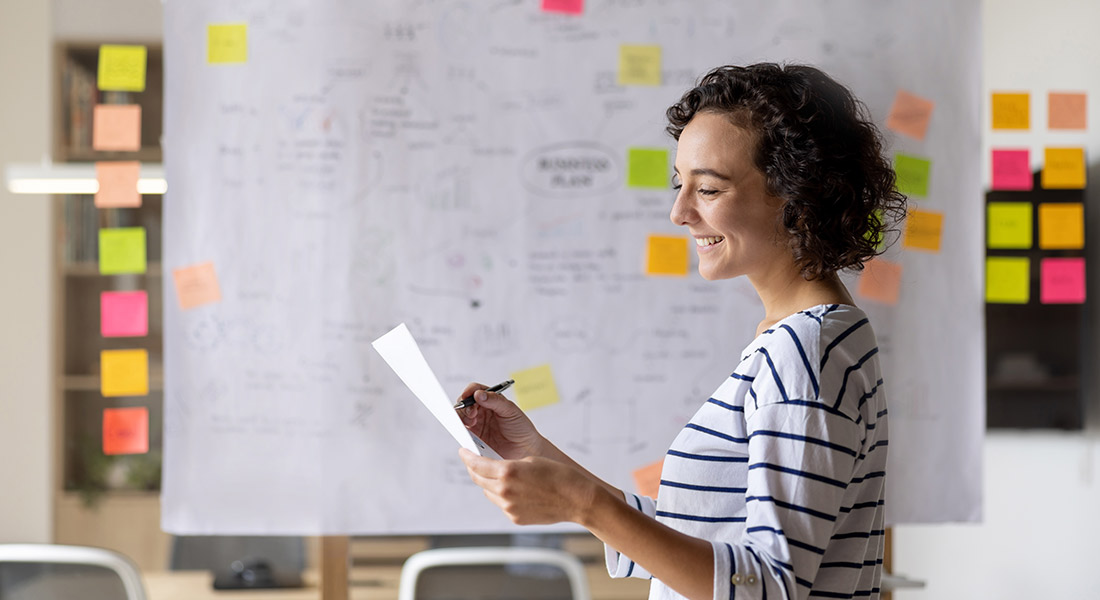 a female business owner in the office strategizing, eight new year business planning ideas